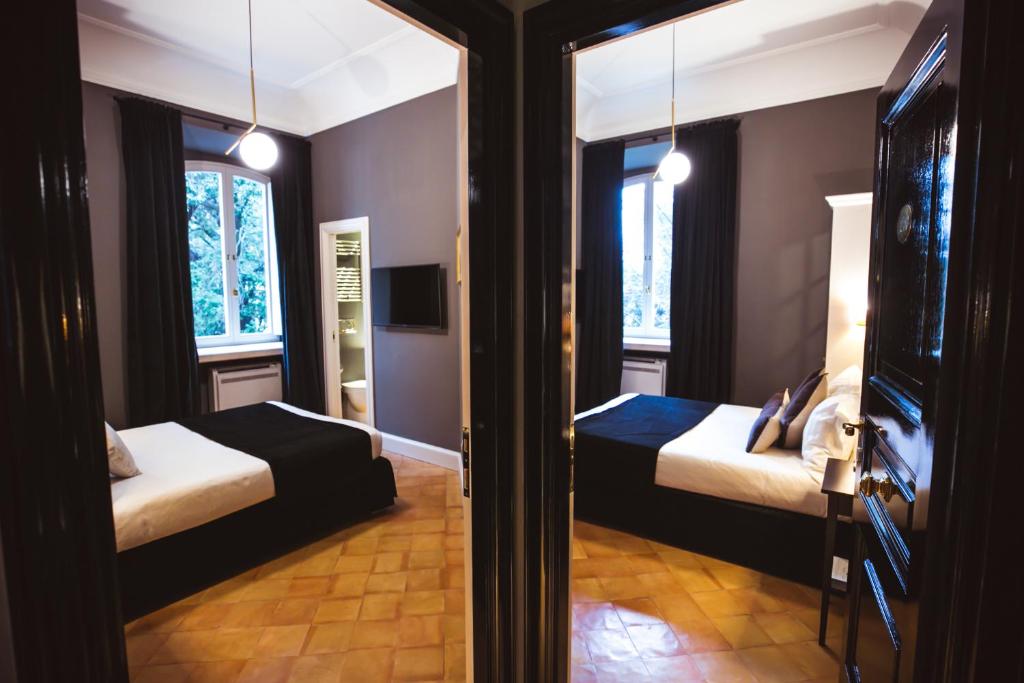The photo depicts a luxurious and elegant hotel room in Trastevere, Rome, exuding sophistication and refinement in every detail.
